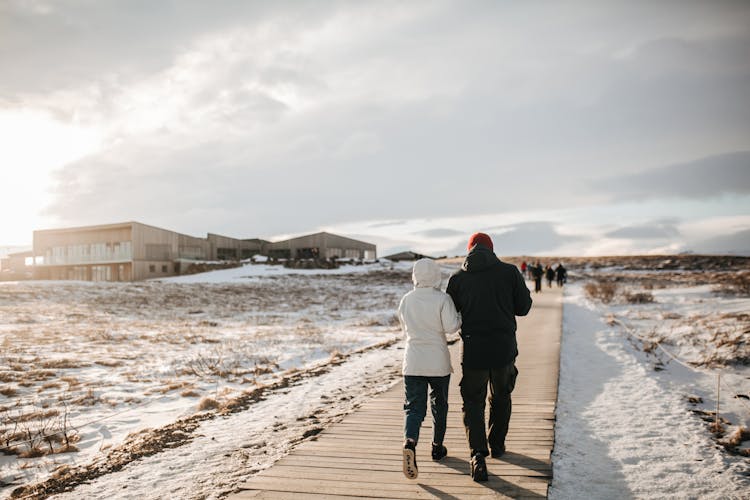 People Walking On A Wooden Walkway