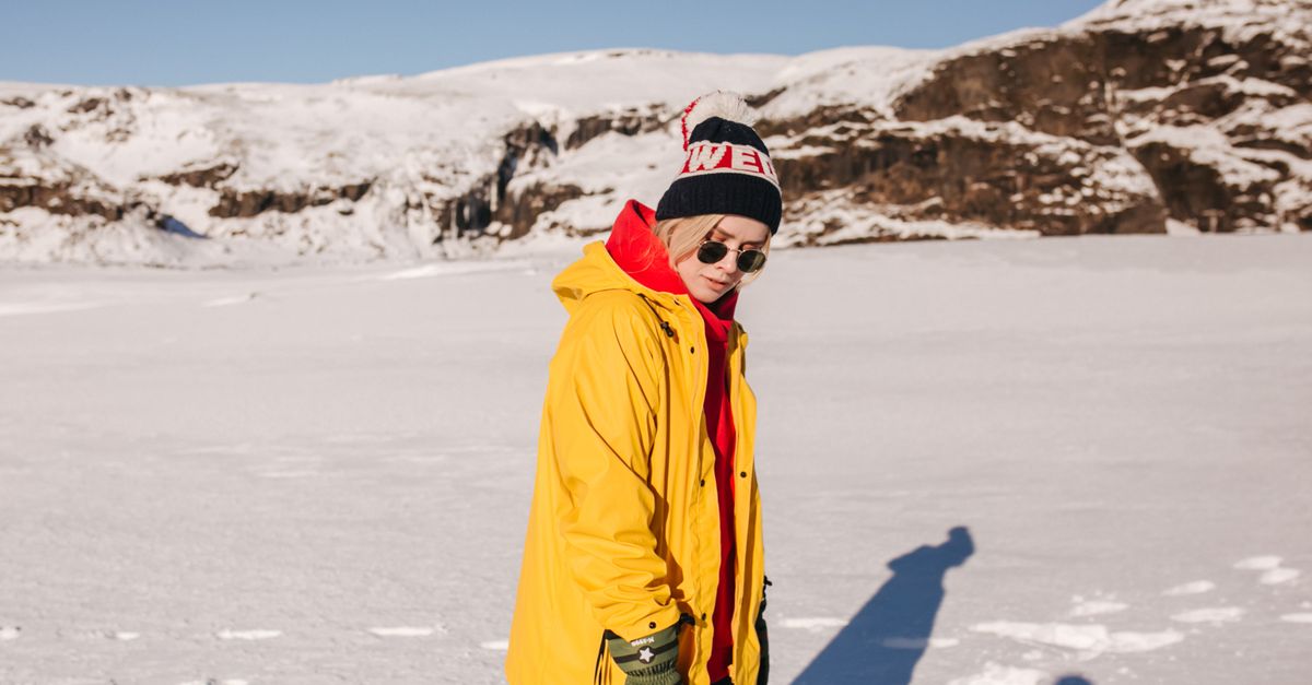 Gen Z travelers hiking on a glacier in Iceland wearing colorful jackets