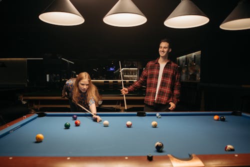 A Man and a Woman Playing Billiards 