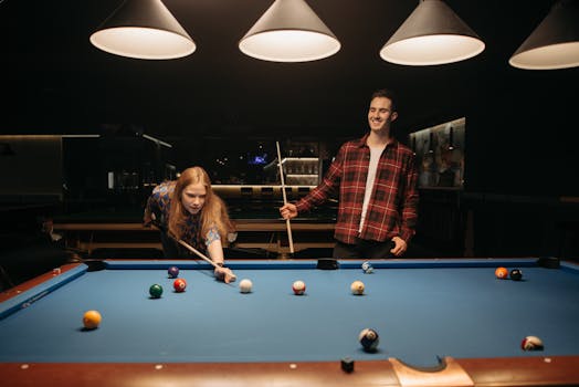 Friends enjoy a casual evening playing billiards, capturing fun and focus.