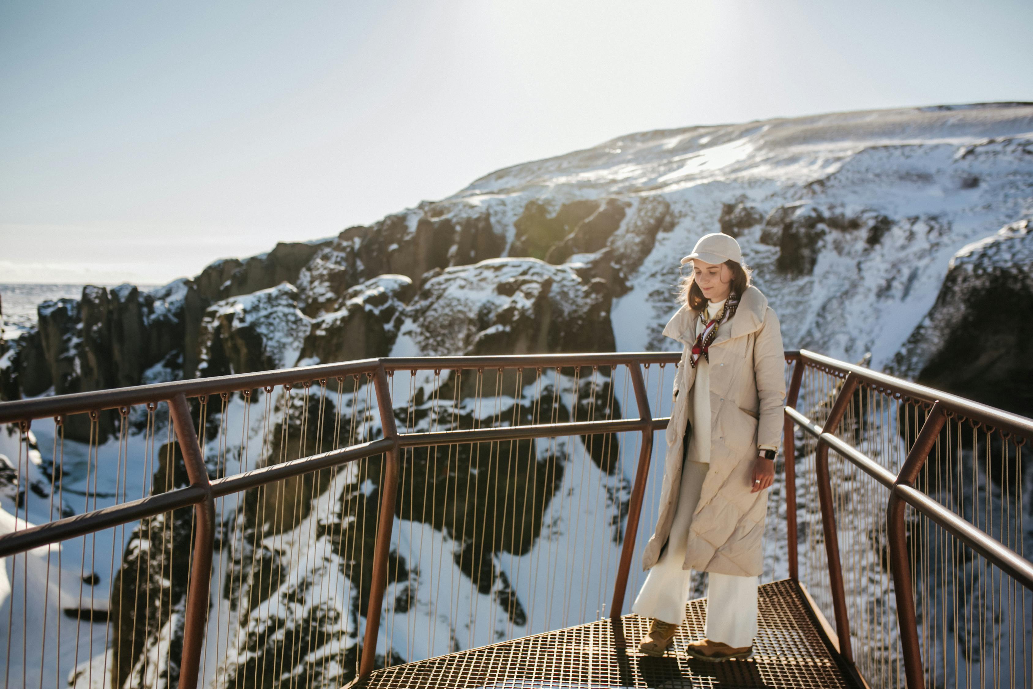 A Woman in Winter Clothing on a View Deck