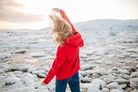Woman in a Red Sweatshirt and Denim Jeans