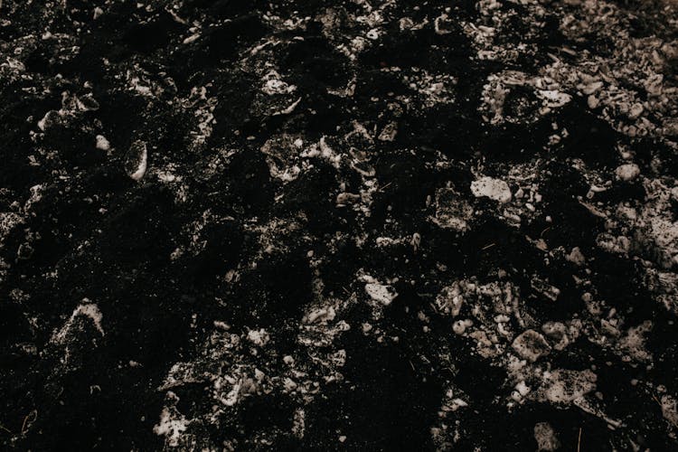 Black, Eroded Rock Surface On Ground