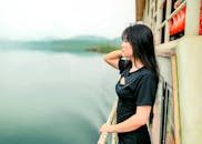 Woman in Black Dress Holding a Handrail