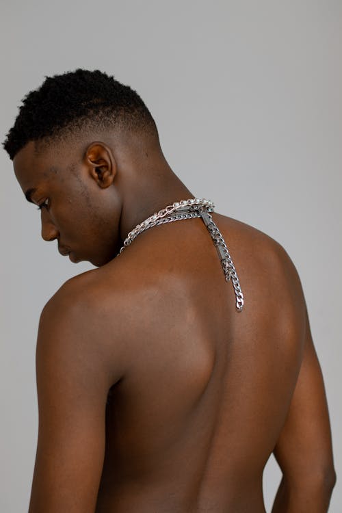 Topless of a Man Wearing Silver Necklaces