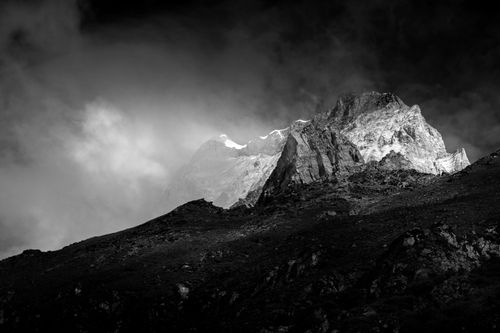 Free A striking black and white mountain scene with a dramatic sky. Stock Photo