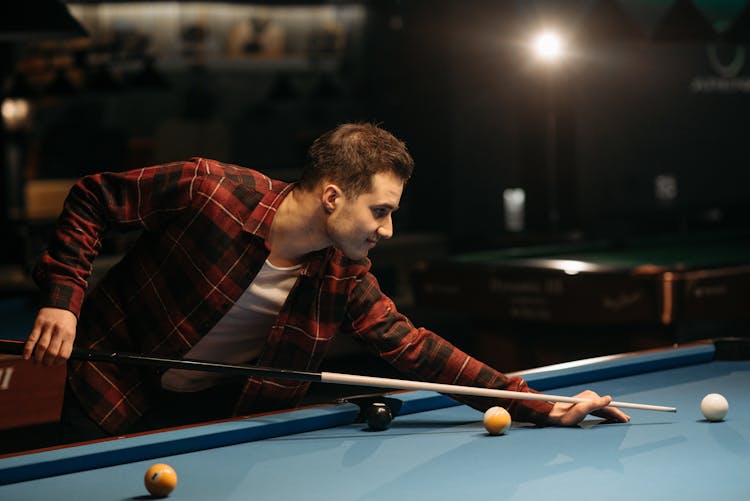 A Man Playing Billiards 