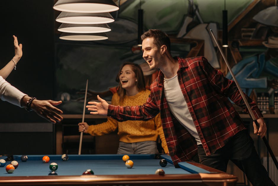 Friends Cheering While Their Friend Aiming For Billiards Ball Stock Photo,  Picture and Royalty Free Image. Image 28035174.
