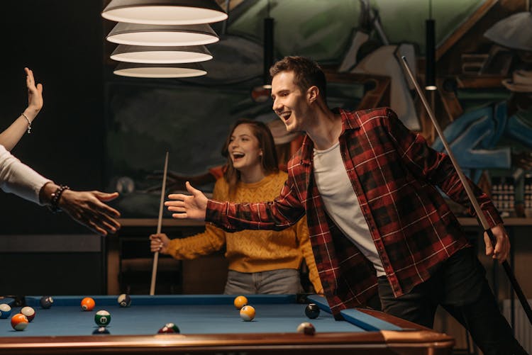 Friends Having Fun Playing Billiards