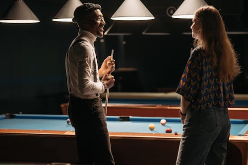 Man and Woman Playing Billiard