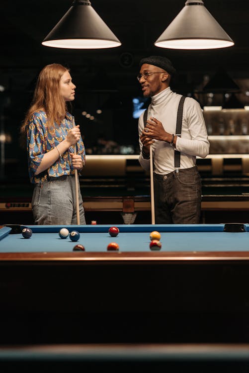 Free Man and Woman Holding Cue Sticks Stock Photo