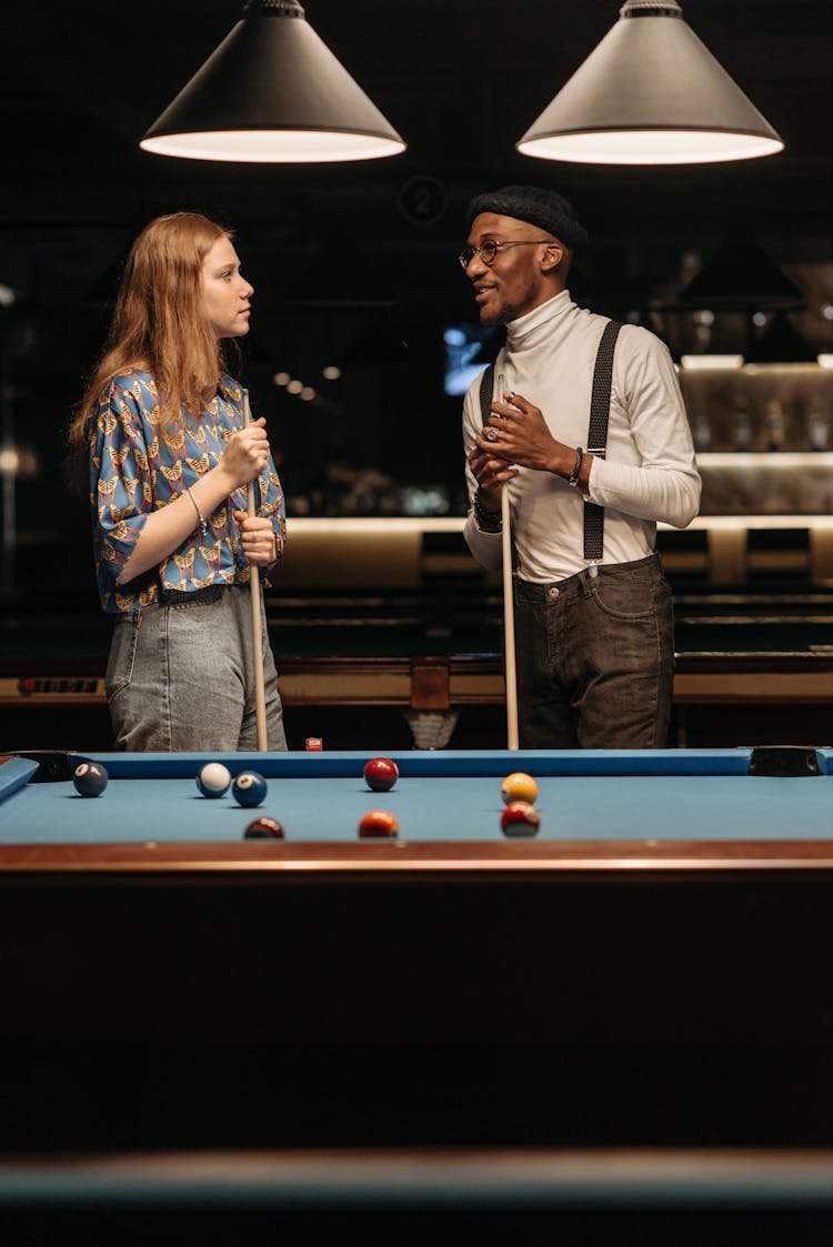 Man And Woman Holding Cue Sticks