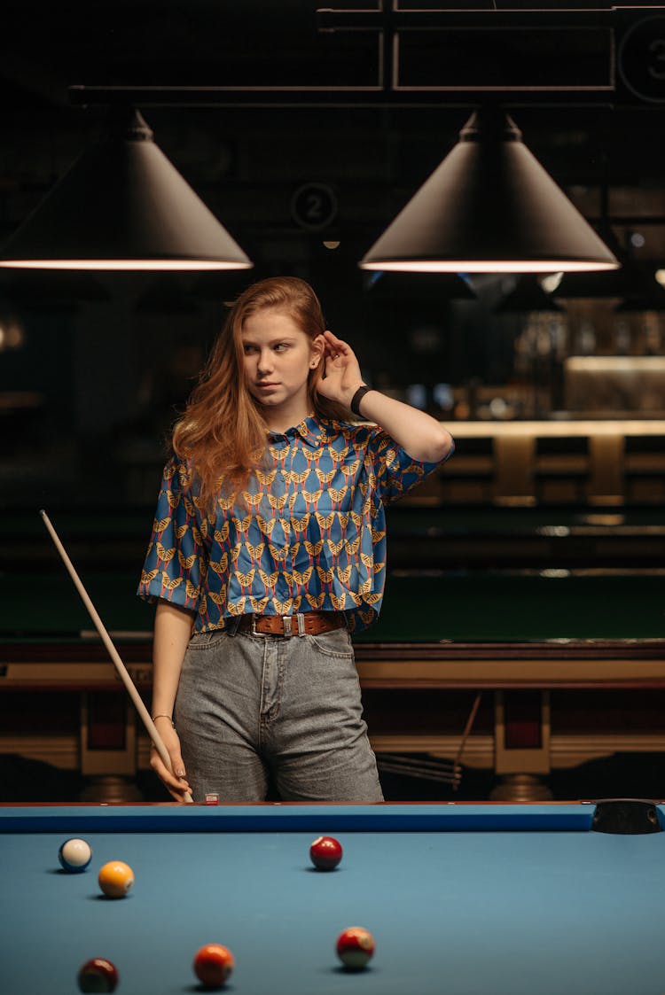 Woman In Printed Blouse Holding A Cue Stick