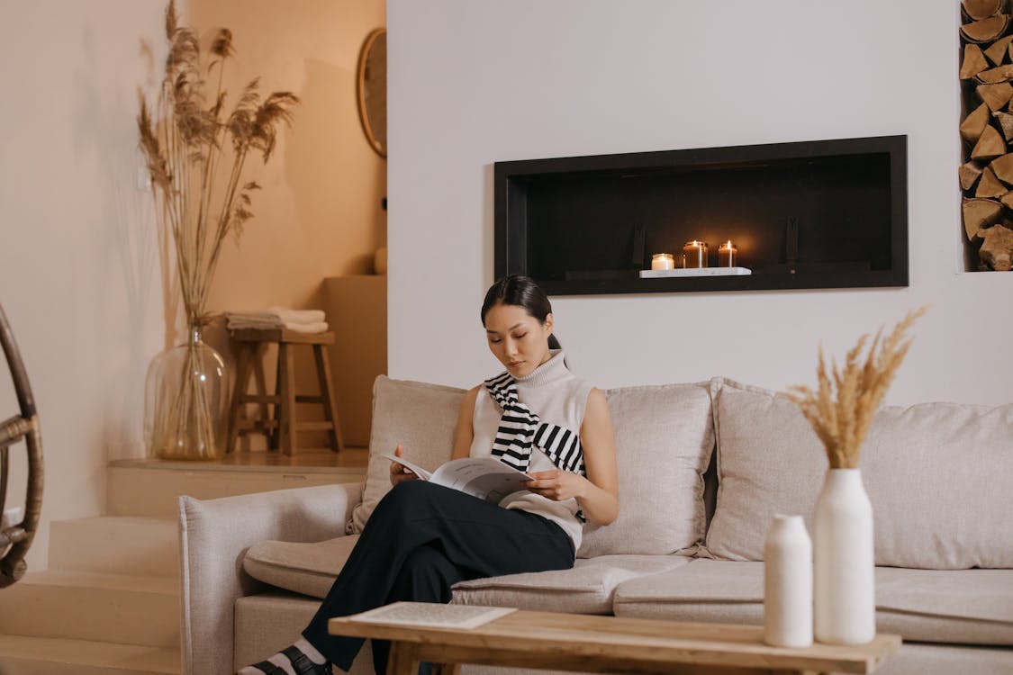 Woman lounging on her beige sofa