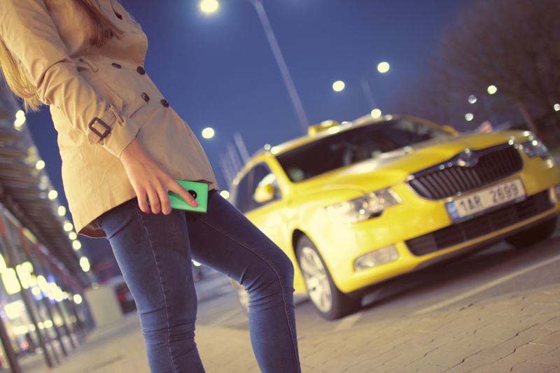 Person checking a phone in a parked car