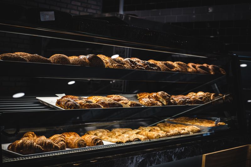 Golden fresh croissants arranged on a bakery counter