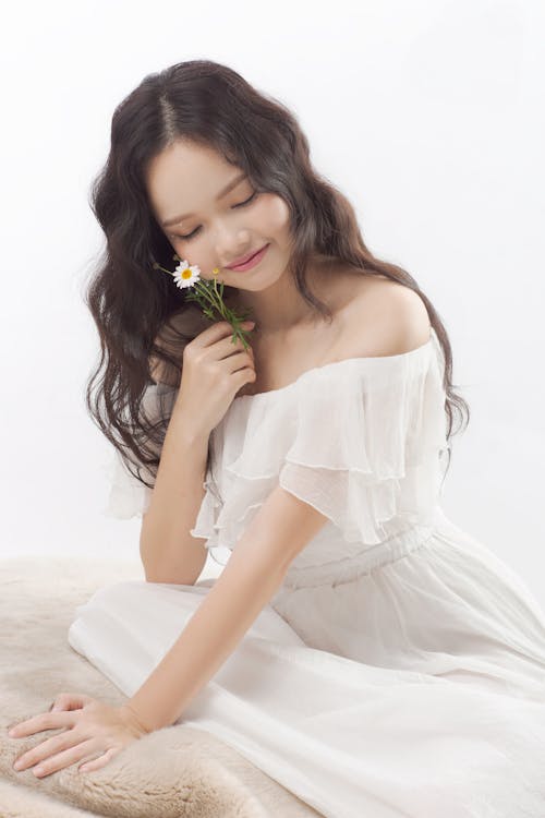 Charming Asian woman with flower