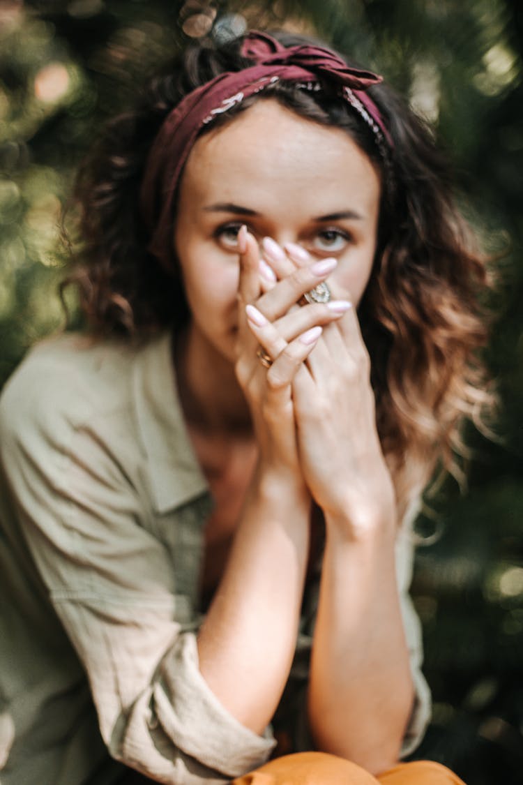 A Woman With Her Hands Covering Her Face