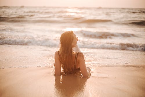 Free A Woman Lying Down on the Shore Stock Photo