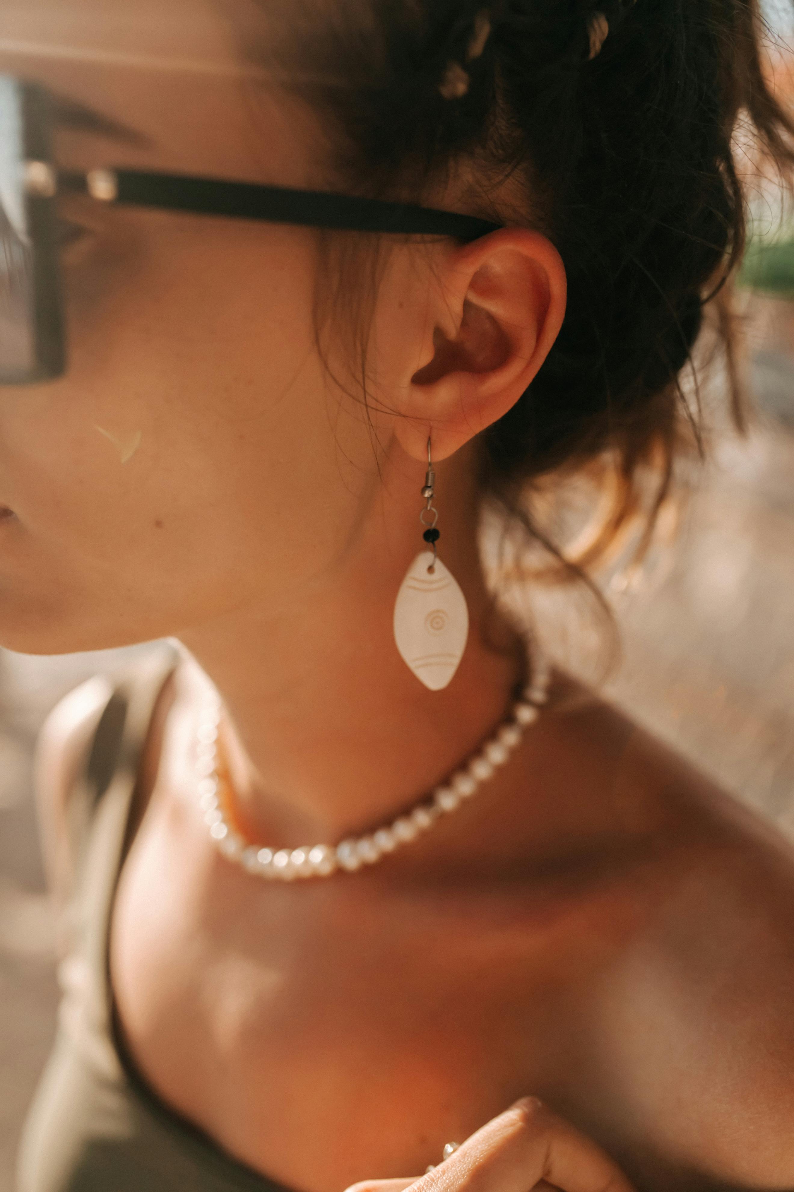 a woman wearing accessories on her ear and neck