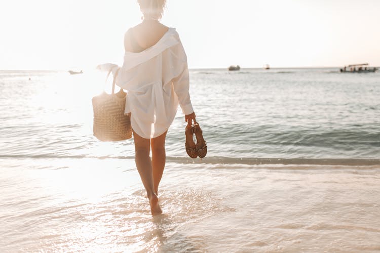 Back View Of A Woman Standing On The Seashore