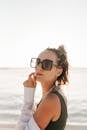 Woman in Black Tank Top Wearing Black Framed Eyeglasses