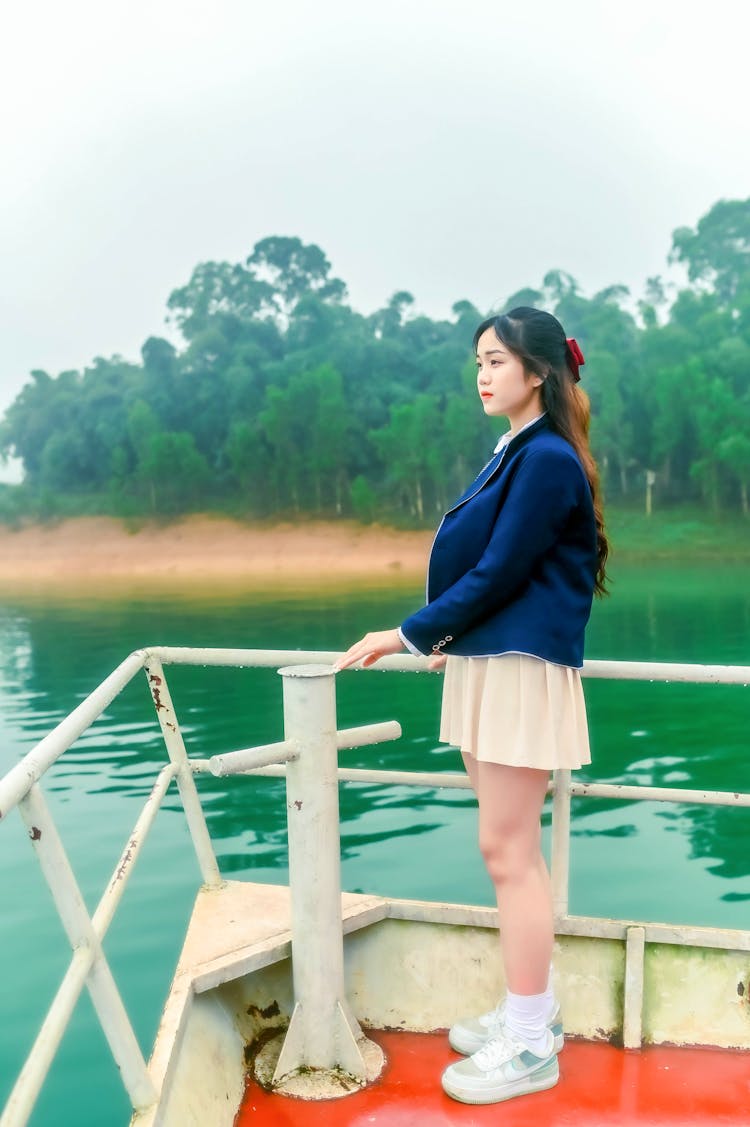 A Girl Holding A Hand Rail Of A Boat