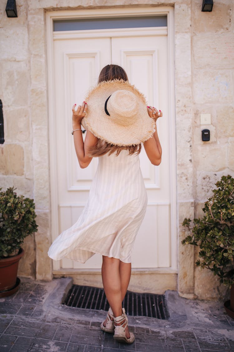 A Woman Standing In Front Of A Door