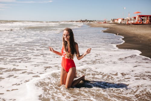 A Woman in a Swimwear Having Fun at the Beach