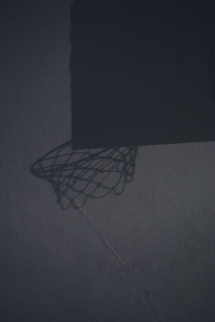 Shadow Of Basketball Hoop On Wall