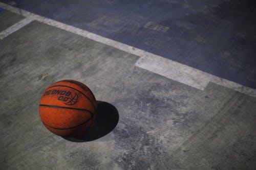 Free Orange basketball ball on playground Stock Photo