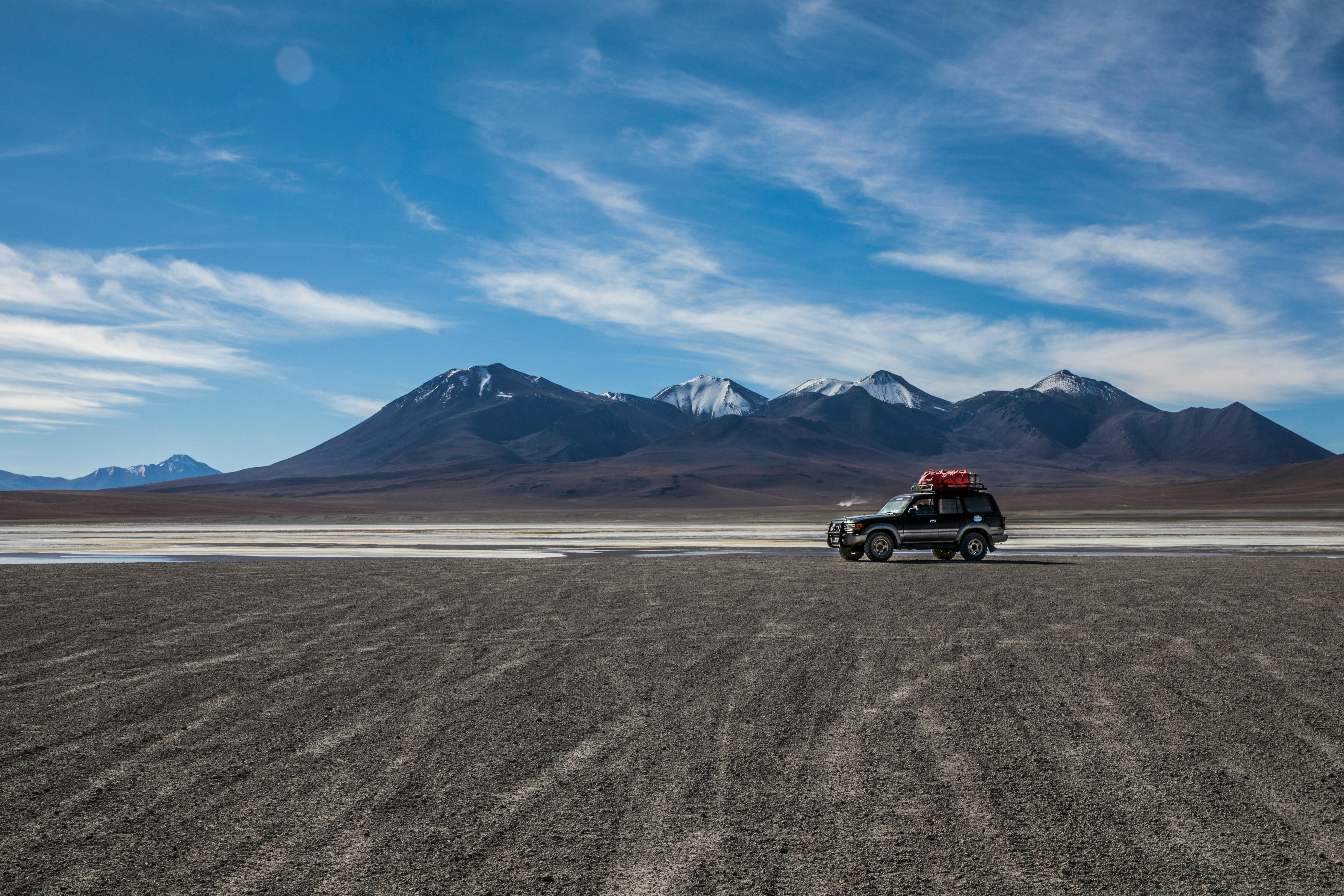 Prescription Goggle Inserts - Explore the stunning desert landscape of Uyuni, Bolivia with an SUV under a bright blue sky.