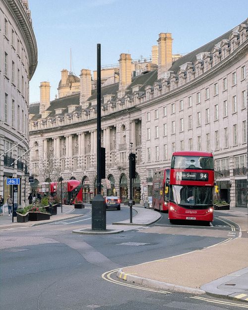 Free Double deck red buses on roadway in aged center of London with classic buildings Stock Photo