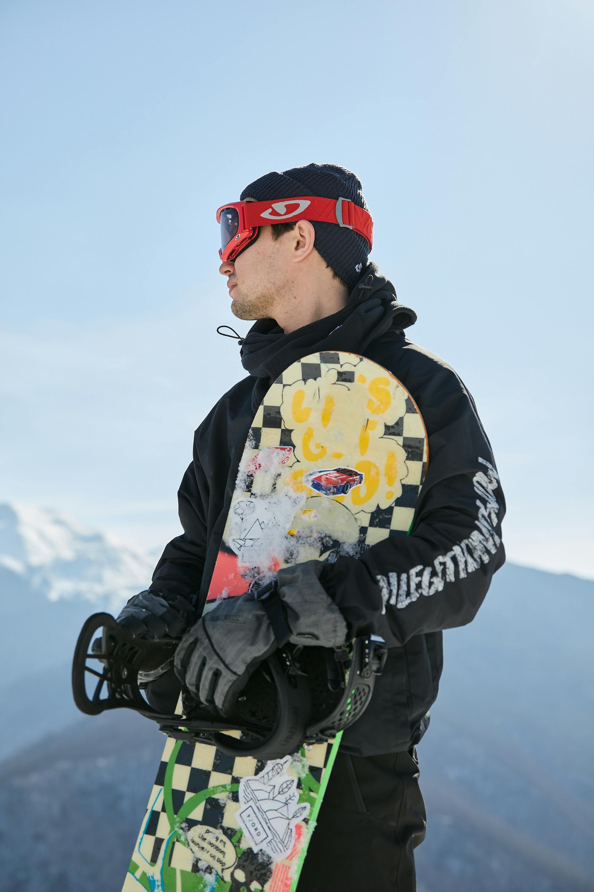 Prescription Goggle Inserts - Snowboarder in winter gear on a snowy mountain resort, ready for action.