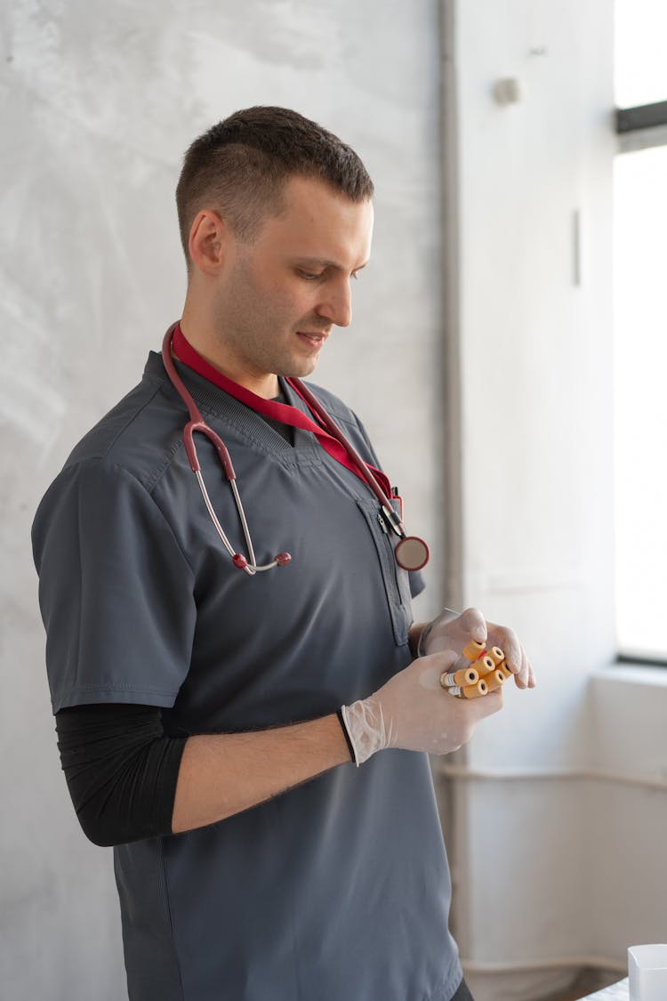 Man Holding Test Tube Samples