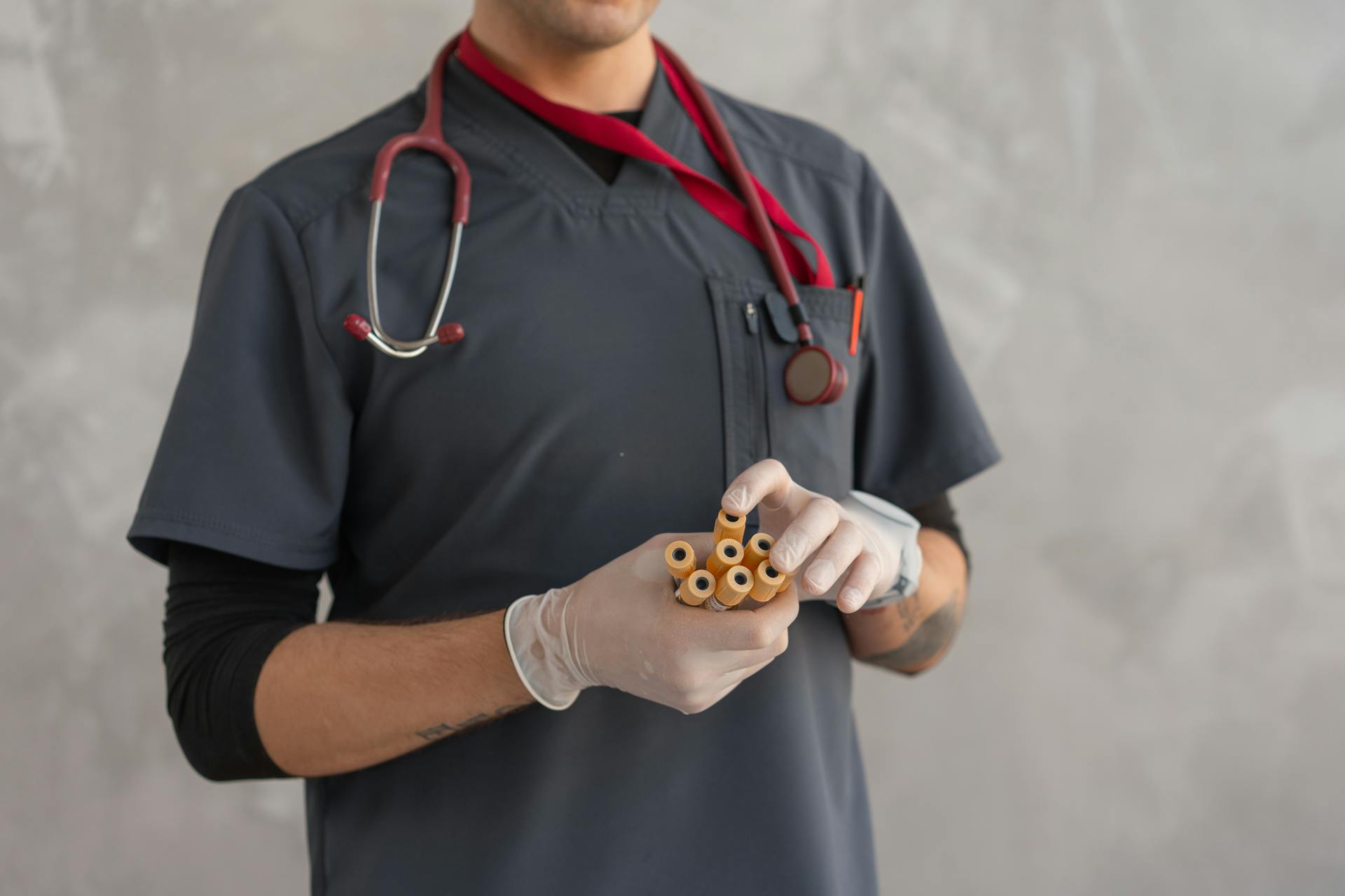 Person Wearing Latex Gloves Holding Test Tube Samples