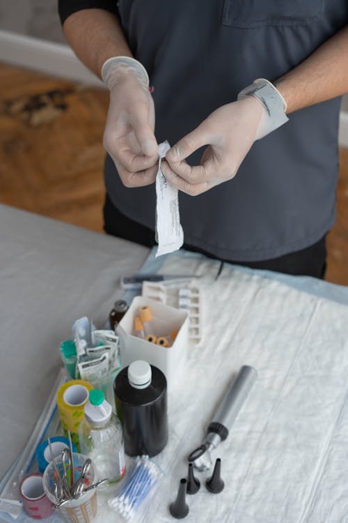 Person Wearing Gloves Preparing Medical Tools