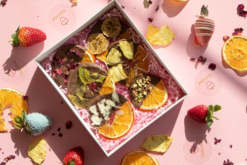 Free A delightful assortment of chocolate dipped dried fruits in a decorative gift box. Stock Photo