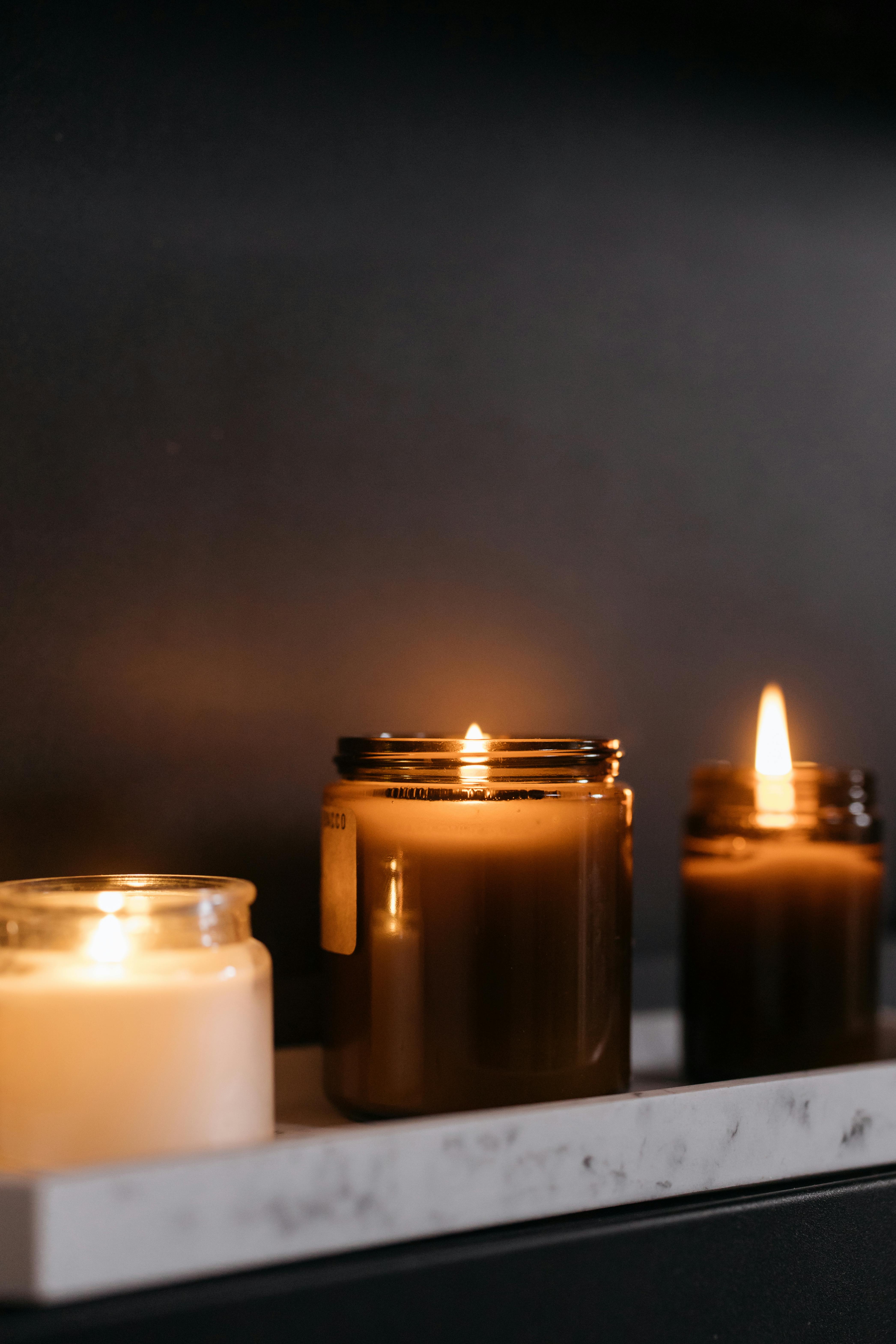 lighted candles on glass jars packaging