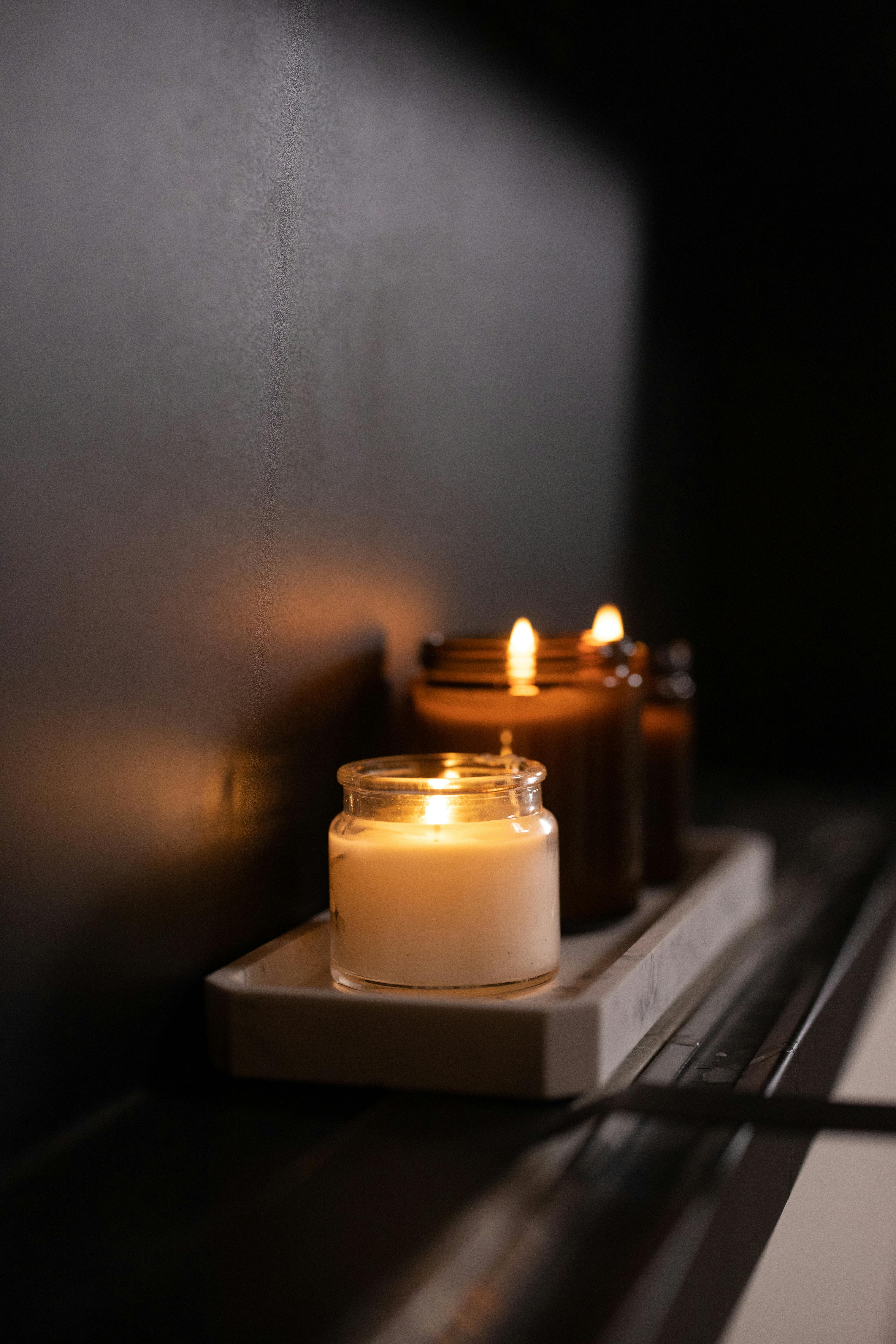 Lighted Candles on Glass Containers · Free Stock Photo