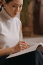 Woman in White Turtleneck Shirt Using Macbook Air
