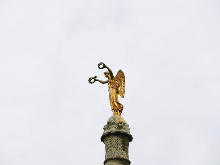 Golden Angel Statue Under White Sky