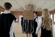 Woman in Black Blazer Holding Brown Cardboard Box