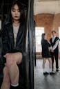 Woman in Black Blazer Sitting on Black Metal Framed Glass Window