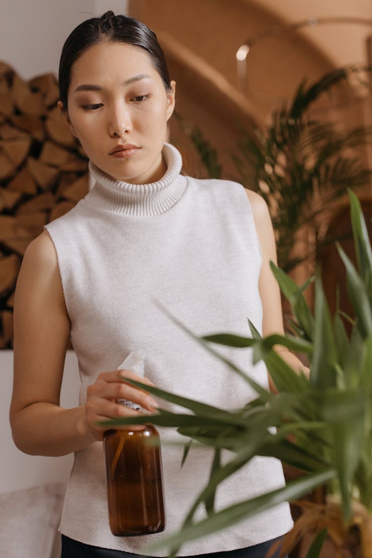 
A Woman Watering A Plant