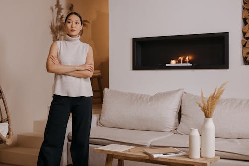 A Cozy Living Room and a Woman with Her Arms Crossed