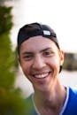 A Smiling Man Wearing Black Cap