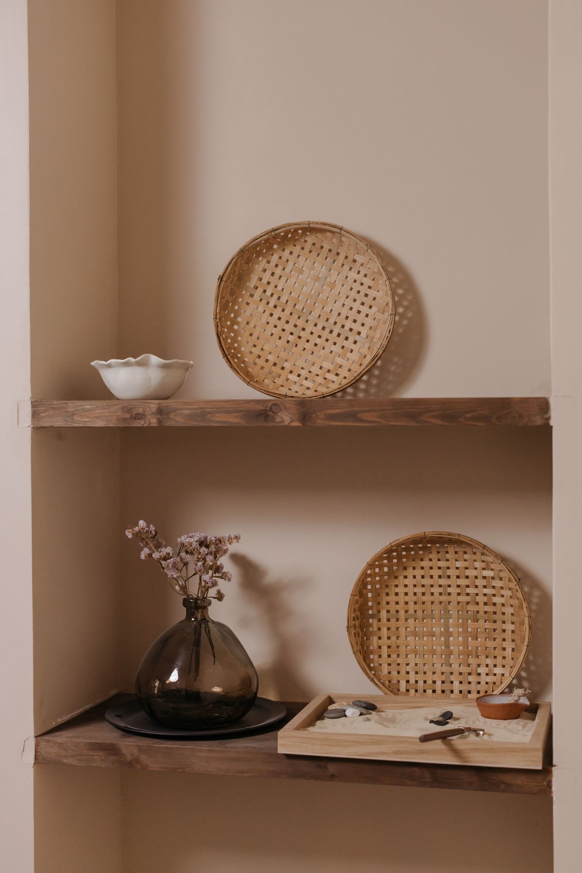Woven storage baskets arranged on minimalist home shelving