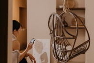 A Woman Using Her Smartphone at Home