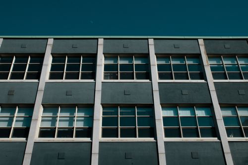 Free Low-angle view of a modern building facade with geometric patterns in Montréal, Canada. Stock Photo